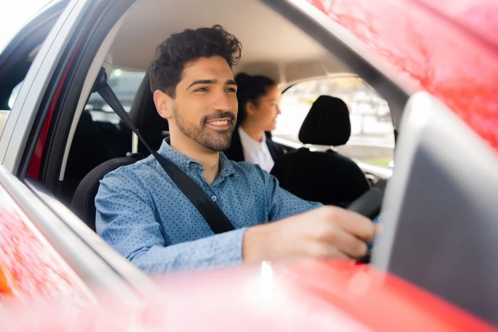 Chades Taxi driver with passenger at back seat.